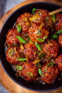 Plate of crispy Cabbage Manchurian garnished with green onions.
