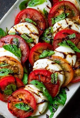 Fresh Caprese Salad with tomatoes, mozzarella, and basil drizzled with balsamic glaze
