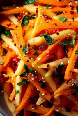 Fresh Carrot Apple Salad with grated carrots and sliced apples served in a bowl.