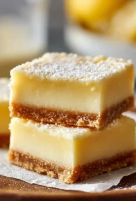 Delicious creamy lemon squares with a buttery crust and vibrant lemon filling