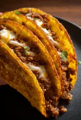 Crispy ground beef tacos served with fresh toppings