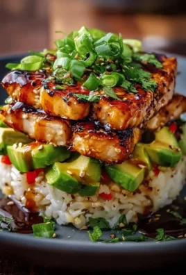 Honey lime chicken served with avocado rice stack on a plate