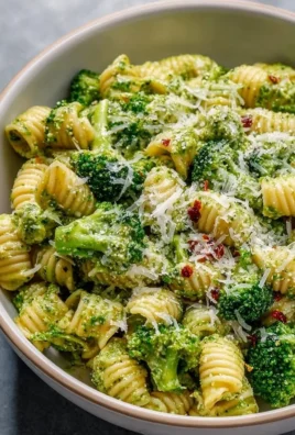 Bowl of easy healthy broccoli pasta topped with parmesan cheese and herbs