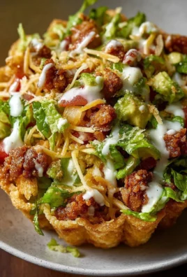 Plate of easy taco cups filled with seasoned meat, cheese, and toppings