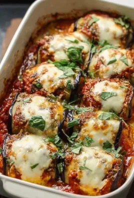 Fluffy Eggplant Rollatini Bake topped with marinara sauce and cheese
