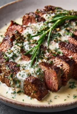 Juicy Garlic Butter Steak topped with rich Parmesan cream sauce