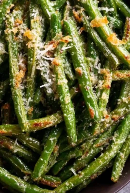 Served dish of Garlic Parmesan Roasted Green Beans garnished with cheese