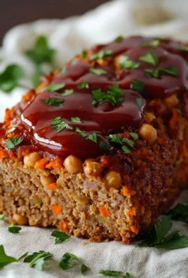 Healthy chickpea meatloaf served on a plate with vegetables