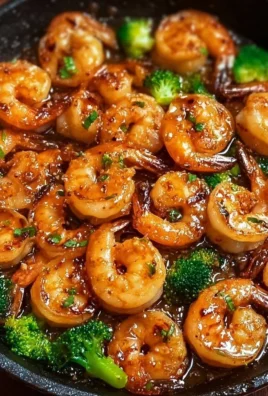 High-protein honey garlic shrimp dish with vibrant vegetables on a plate.
