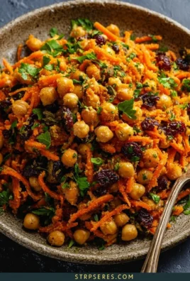 Moroccan carrot and chickpea salad with spices and herbs in a bowl