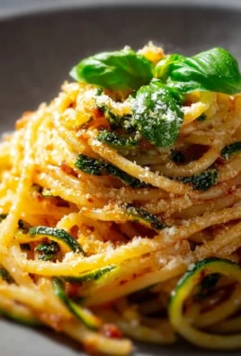 A plate of delicious Nerano Spaghetti with fresh zucchini and cheese.