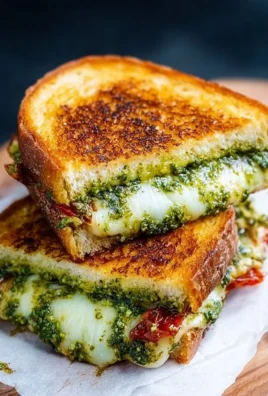 Mouth-watering pesto grilled cheese sandwich with melted cheese and vibrant pesto spread
