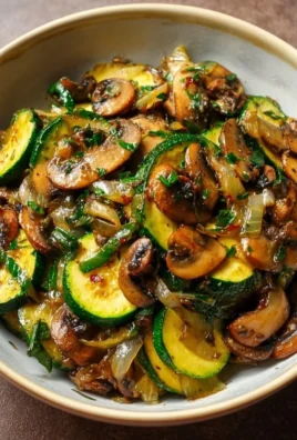 Sauteed zucchini with mushrooms and onions in a skillet