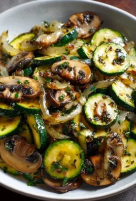 Dish of sautéed zucchini with mushrooms and onions on a plate