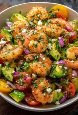 Fresh shrimp salad with vegetables and dressing served in a bowl