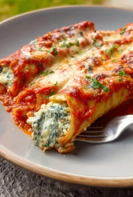 Delicious Spinach and Cheese Manicotti served with marinara sauce and topped with parmesan.