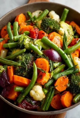Colorful steamed vegetable medley with broccoli, carrots, and bell peppers