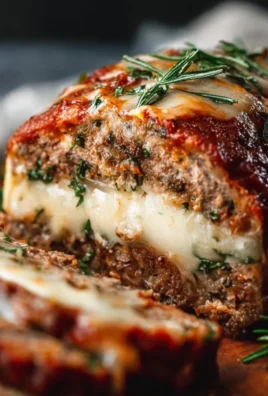 Delicious stuffed Italian meatloaf with herbs and rich tomato sauce