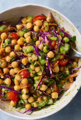 Thai-inspired chickpea salad with vibrant vegetables and dressing.