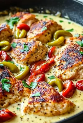 Creamy banana pepper chicken skillet cooked in a cast iron pan with colorful peppers.