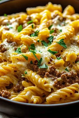 Creamy high protein beef pasta dish with fresh herbs and cheese
