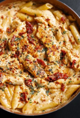 Plate of creamy sun-dried tomato pasta with chicken and mozzarella sauce