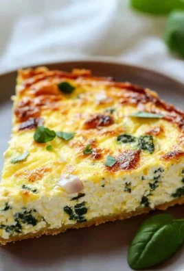 Crustless ricotta quiche slice served on a plate with fresh herbs