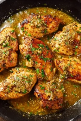 Delicious Garlic Butter Chicken served with herbs and vegetables