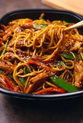 High Protein Chicken Chow Mein with vegetables and chicken in a bowl