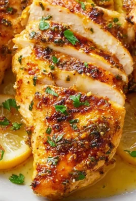 Delicious Lemon Garlic Chicken dish garnished with herbs and lemon slices.