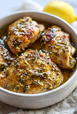 Lemon and garlic Greek marinated chicken served on a plate with herbs.