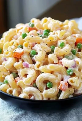 Delicious macaroni salad in a bowl, garnished with fresh herbs.