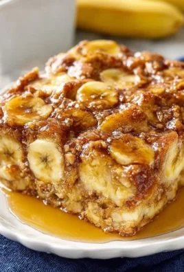 Overnight Baked Banana French Toast Casserole topped with fresh bananas and syrup