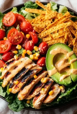 Bowl of Southwest avocado chicken salad with colorful veggies and chicken.