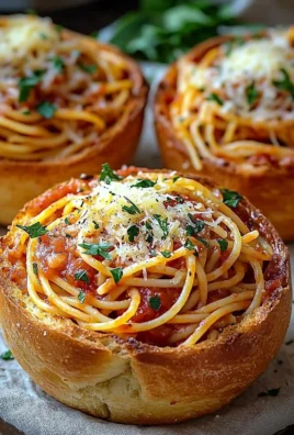 Spaghetti garlic bread bowl filled with savory pasta and garlic bread crust