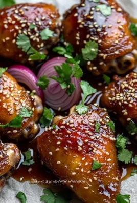 Baked Sticky Honey Soy Chicken garnished with sesame seeds and spring onions