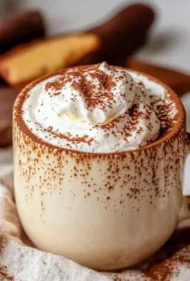 Tiramisu Latte served in a coffee cup with chocolate dust and cocoa