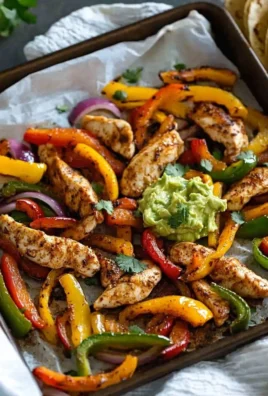 Colorful Whole30 Sheet Pan Fajitas with chicken, peppers, and onions ready to serve.