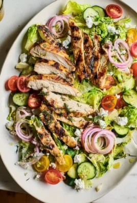 Fresh grilled chicken salad with mixed greens and vibrant vegetables