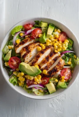 Fresh grilled chicken salad with mixed greens and colorful vegetables