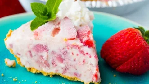 Delicious Strawberry Icebox Pie topped with fresh strawberries and whipped cream