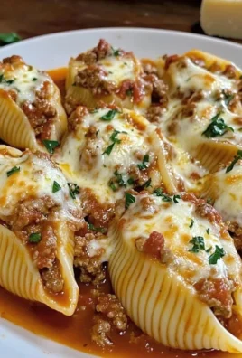 Delicious stuffed pasta shells filled with ricotta and marinara sauce on a plate.