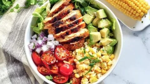 Zesty grilled chicken salad with avocado and honey-lime vinaigrette on a plate