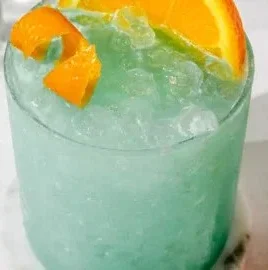 Delicious Blue Hawaiian Mocktail served in a glass with tropical decorations