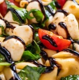 Delicious Caprese Tortellini Salad with mozzarella, basil, and tomatoes
