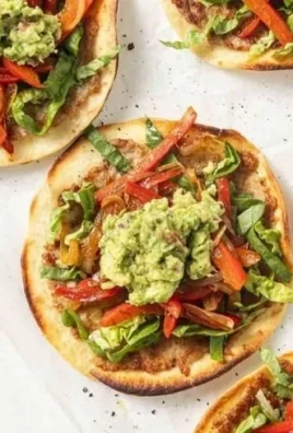 Chicken fajita smashburger tacos served on a plate with fresh toppings.