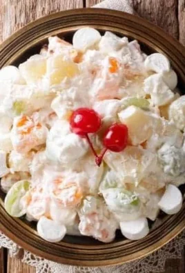 Creamy fruit salad with a variety of fruits in a bowl