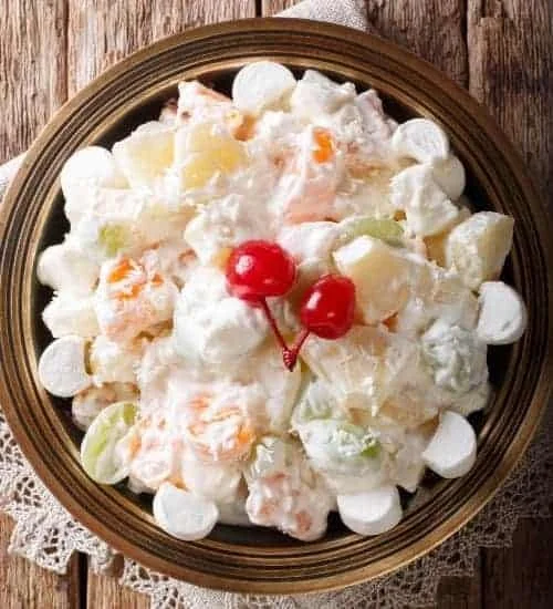 Creamy fruit salad with a variety of fruits in a bowl