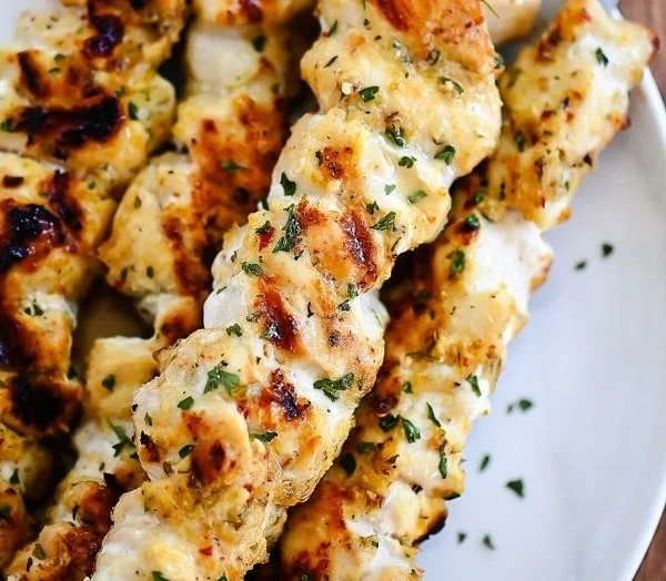 Garlic Parmesan Chicken Kebabs with grilled vegetables served on a plate