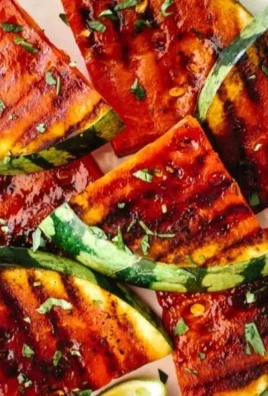 Grilled watermelon slices drizzled with honey and garnished with lime and cilantro